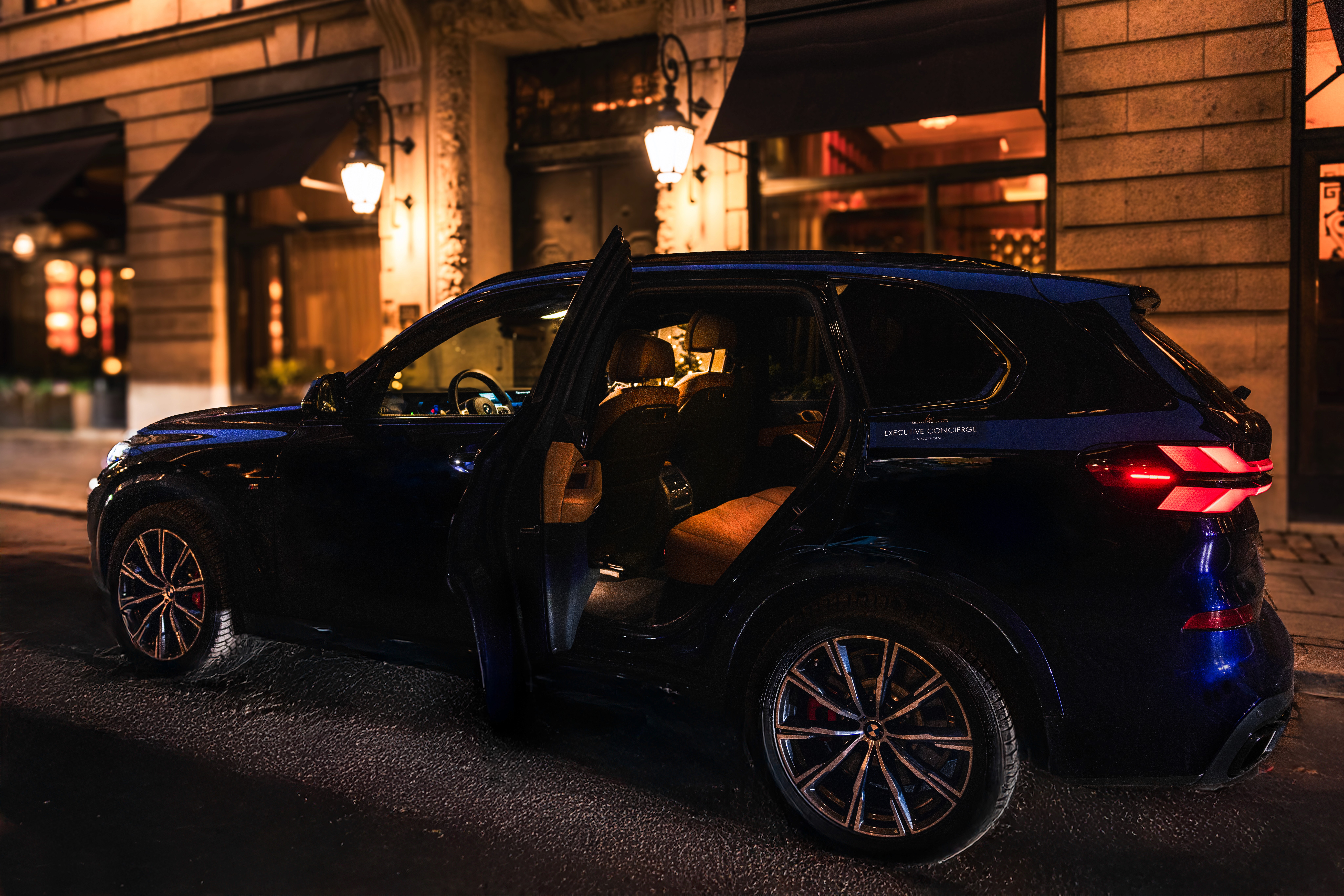 A black car parked next to a fire hydrant