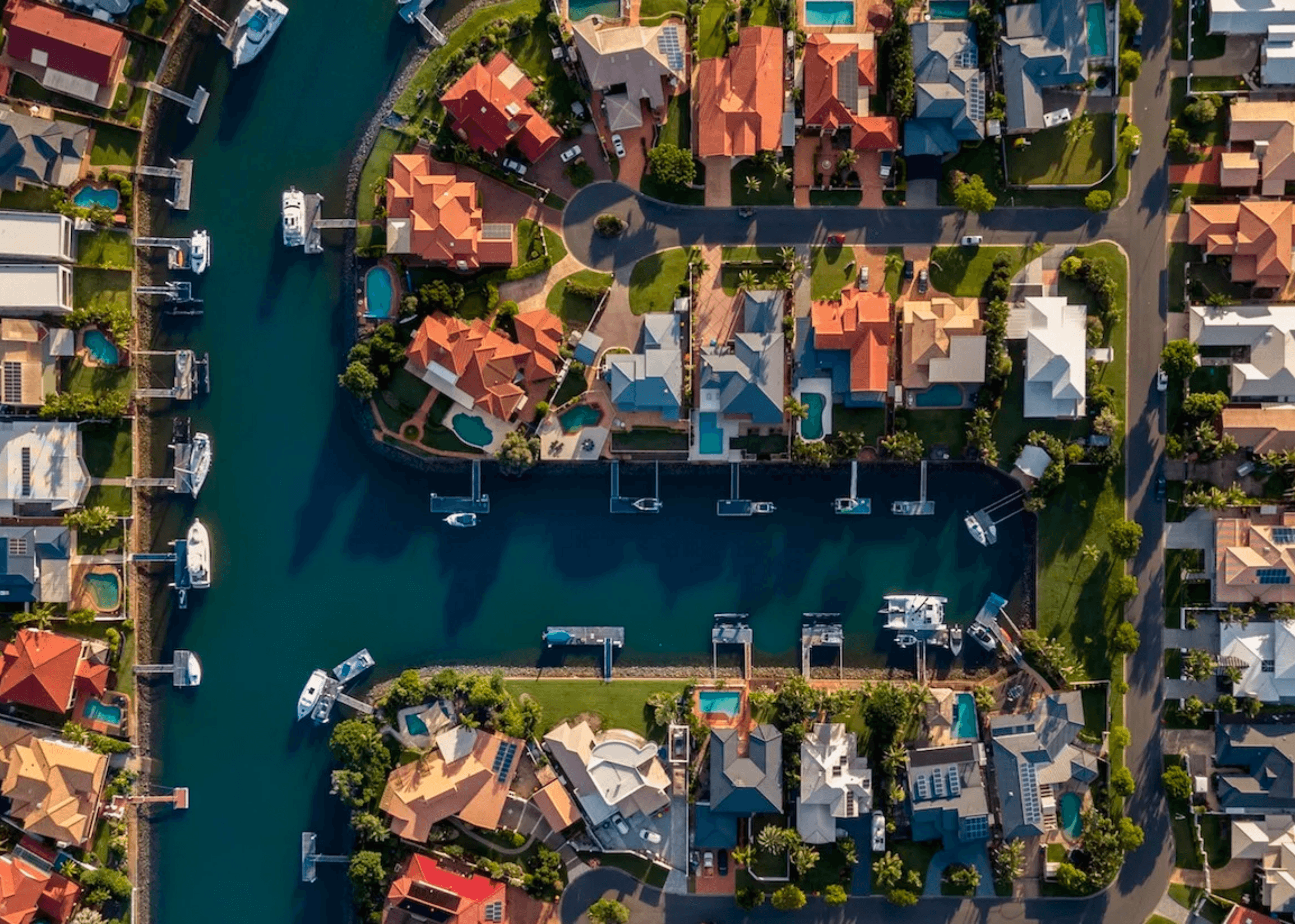 Waterfront houses and boats from aerial view.