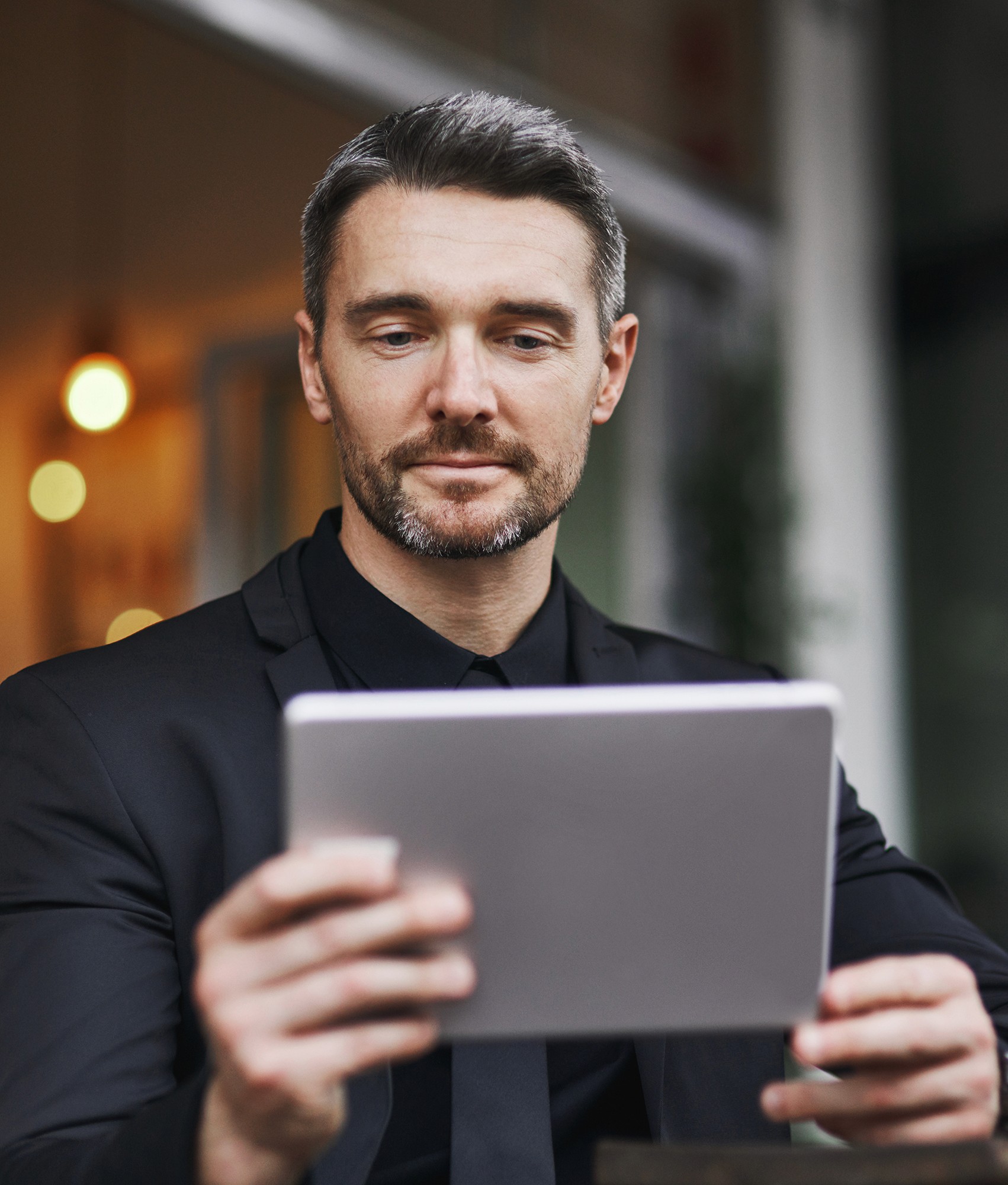 Business person looking at their tablet