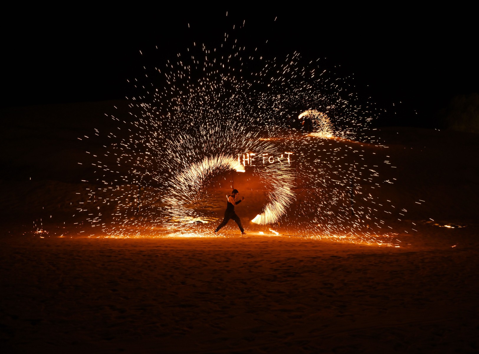 A spectacular live fire show performance at The Fort Al Lisaili during a Dune Quest Tours desert safari dinner in Dubai