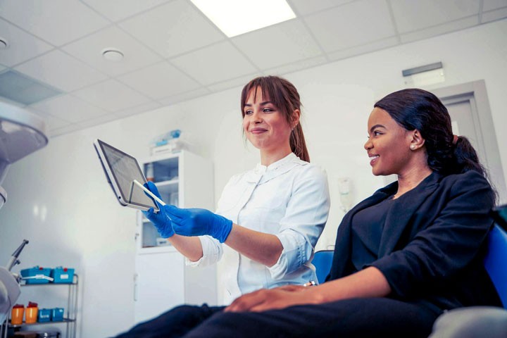 Dentist showing patient some information.