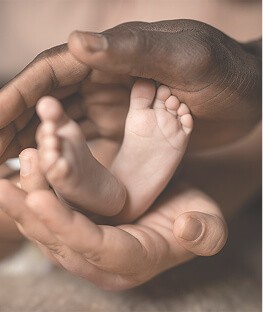 hands cradling baby feet