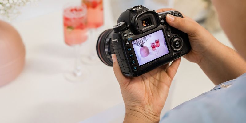 A Malaysian business owner taking a photo of two beverages