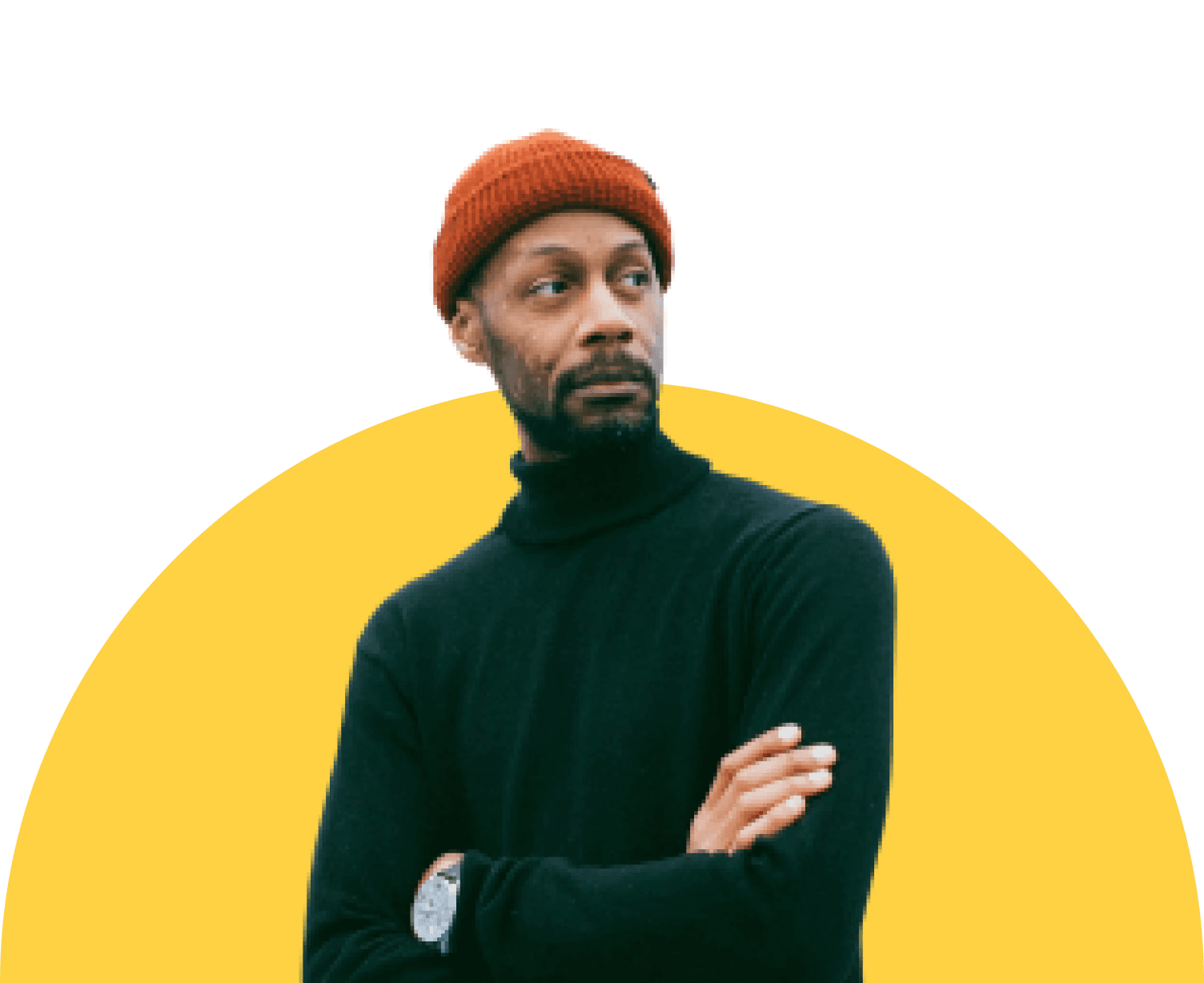 Man in a black turtleneck and orange beanie stands with arms crossed, looking to the side against a clean background