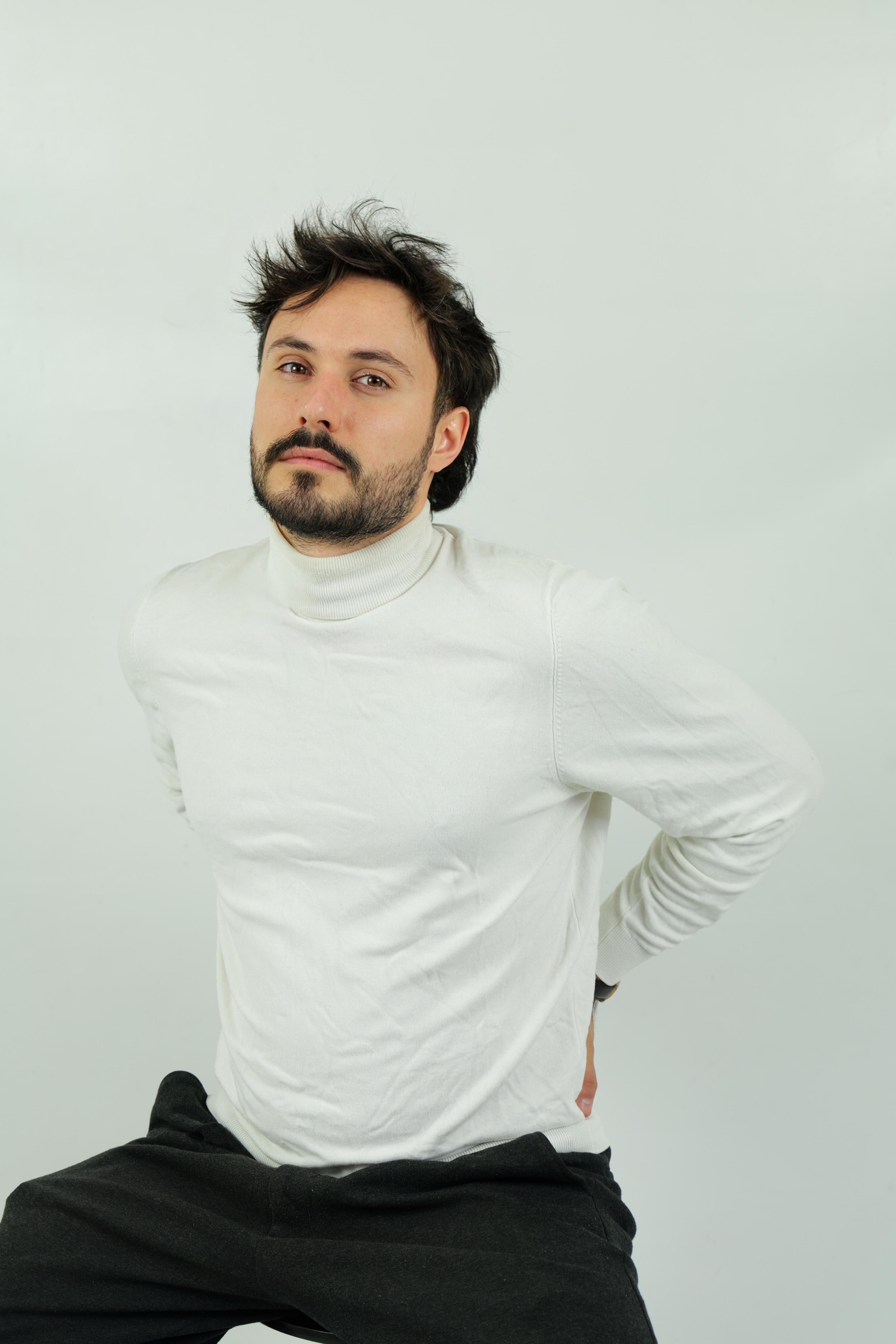 A glamorous cabaret performer with long hair, wearing an elegant white cutout dress, standing mysteriously by a dark piano under dramatic, cinematic slatted lighting
