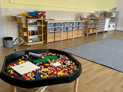 Smyslový stůl (tuff tray) se stavebnicí uprostřed třídy