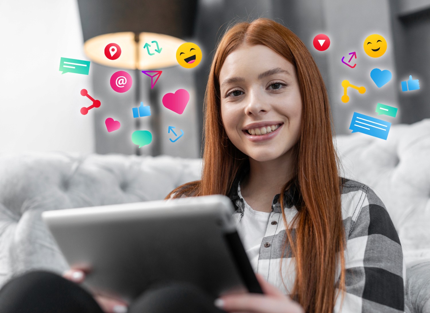 A girl with red hair relaxes on a couch, engaged with a tablet, with social media icons displayed around her.