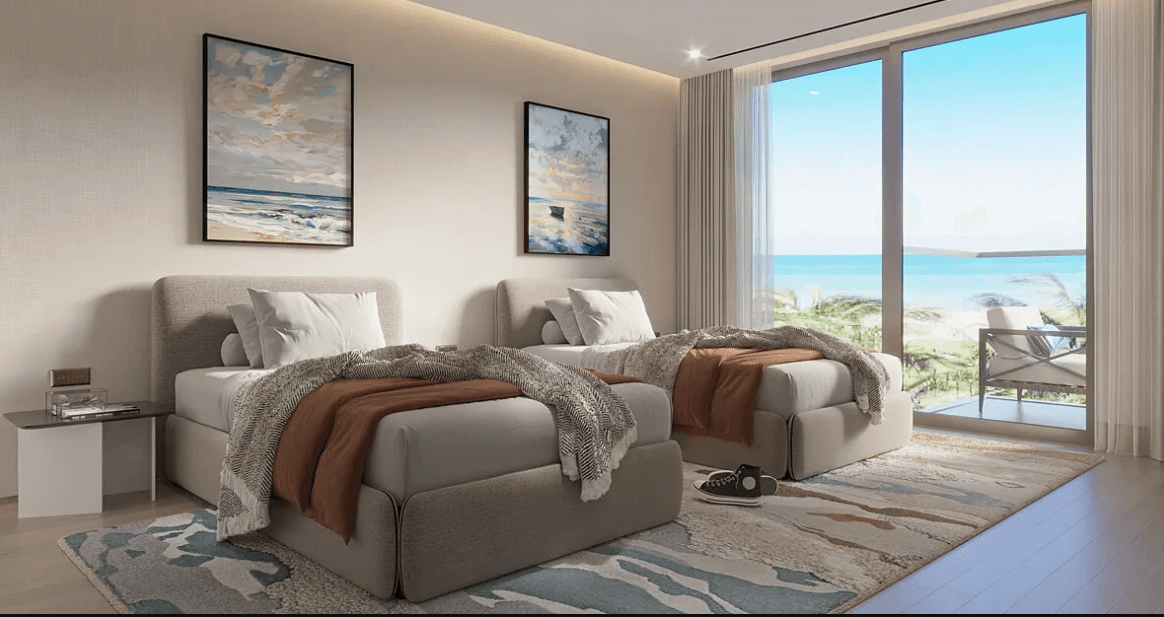 Sleek bedroom design at Edgewater Residences showcasing a white bed with brown pillows.