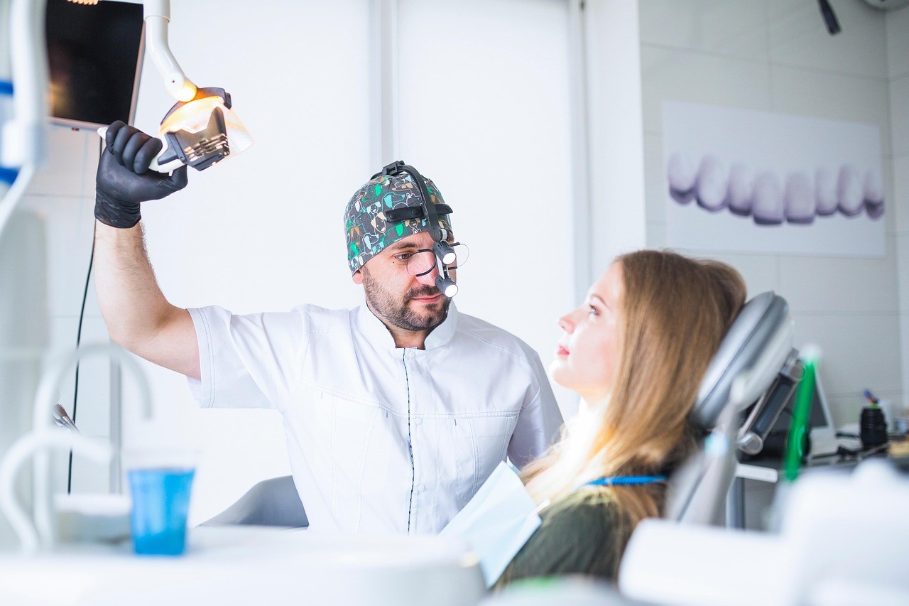 A man getting his teeth checked by a dentist