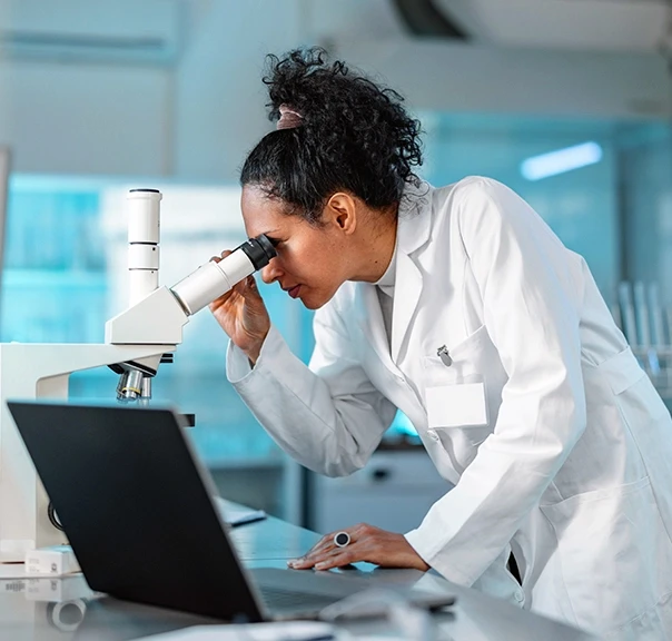 Doctor conducting microscopic examination in a lab, highlighting medical research and documentation for burn injury claims