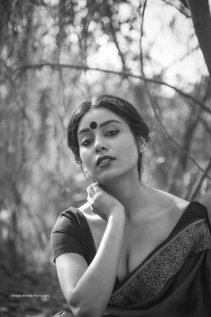 Black and white photo of a woman wearing a saree