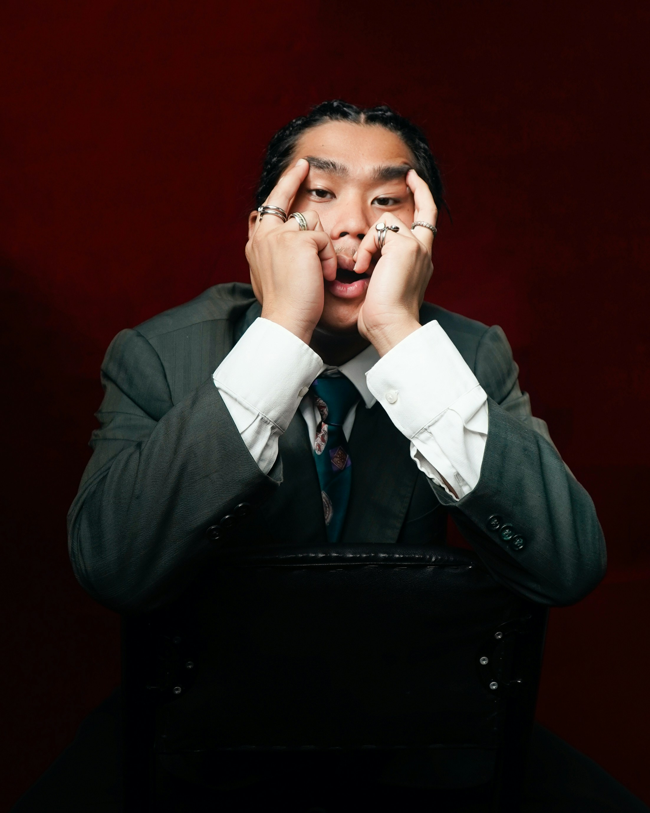 Man in suit with hands on face