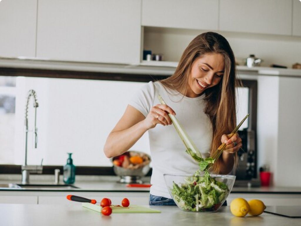 A woman skillfully slicing vegetables in a kitchen, showcasing her culinary expertise.