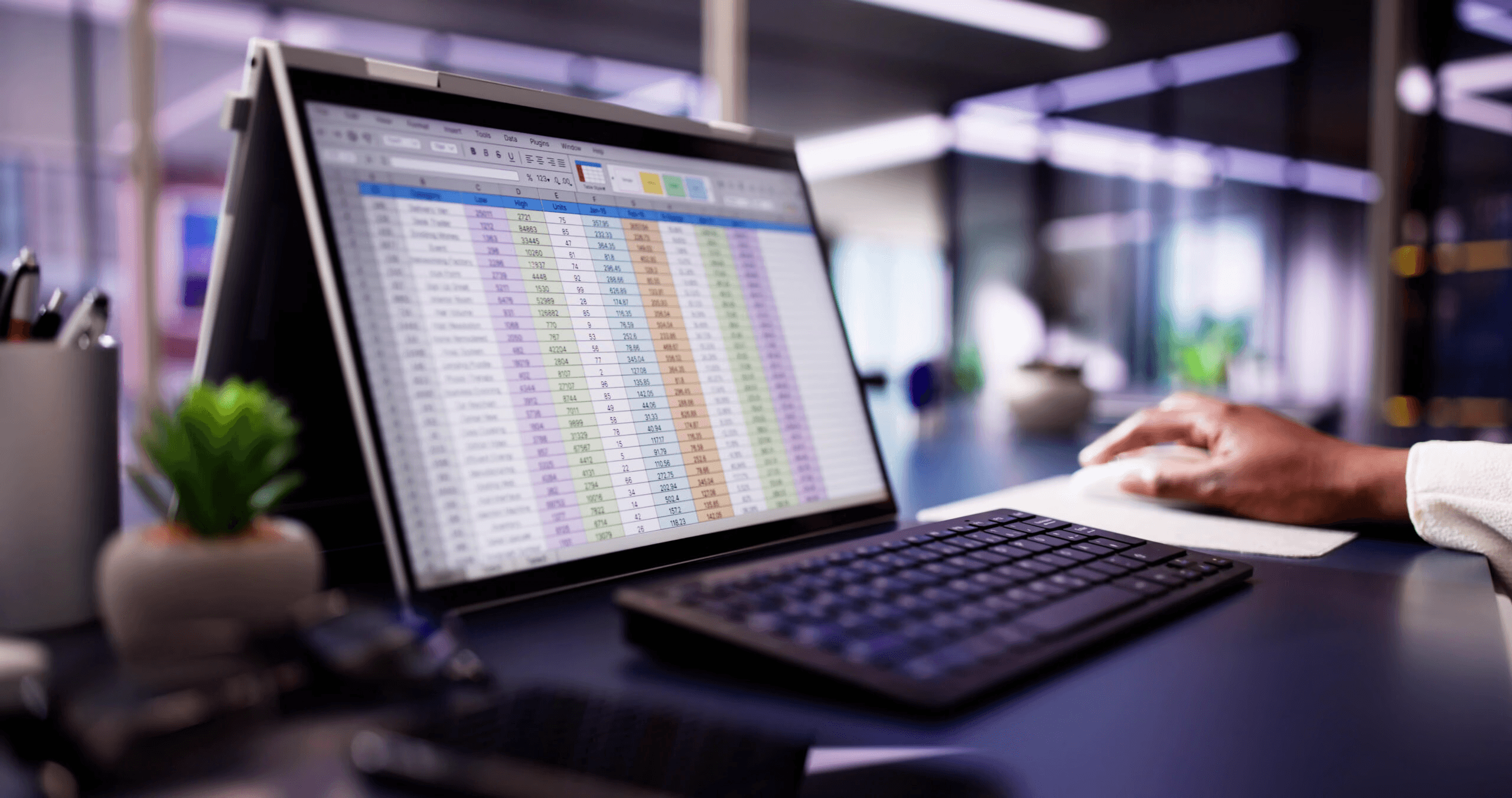 Person working on spreadsheet data - Best Excel Course for Financial Analyst