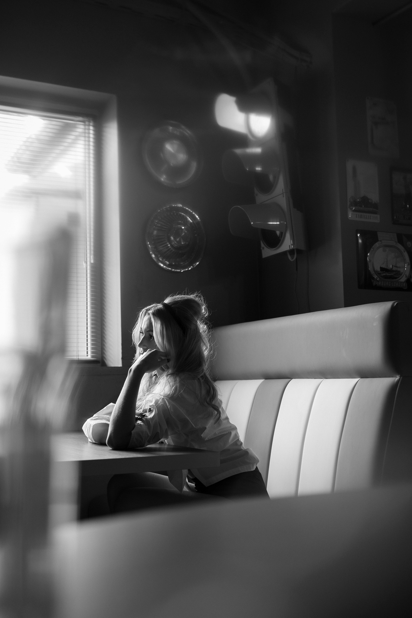 Agnieszka Czyzkowska fine art photography Warsaw woman sitting by window blinds glass of water black and white