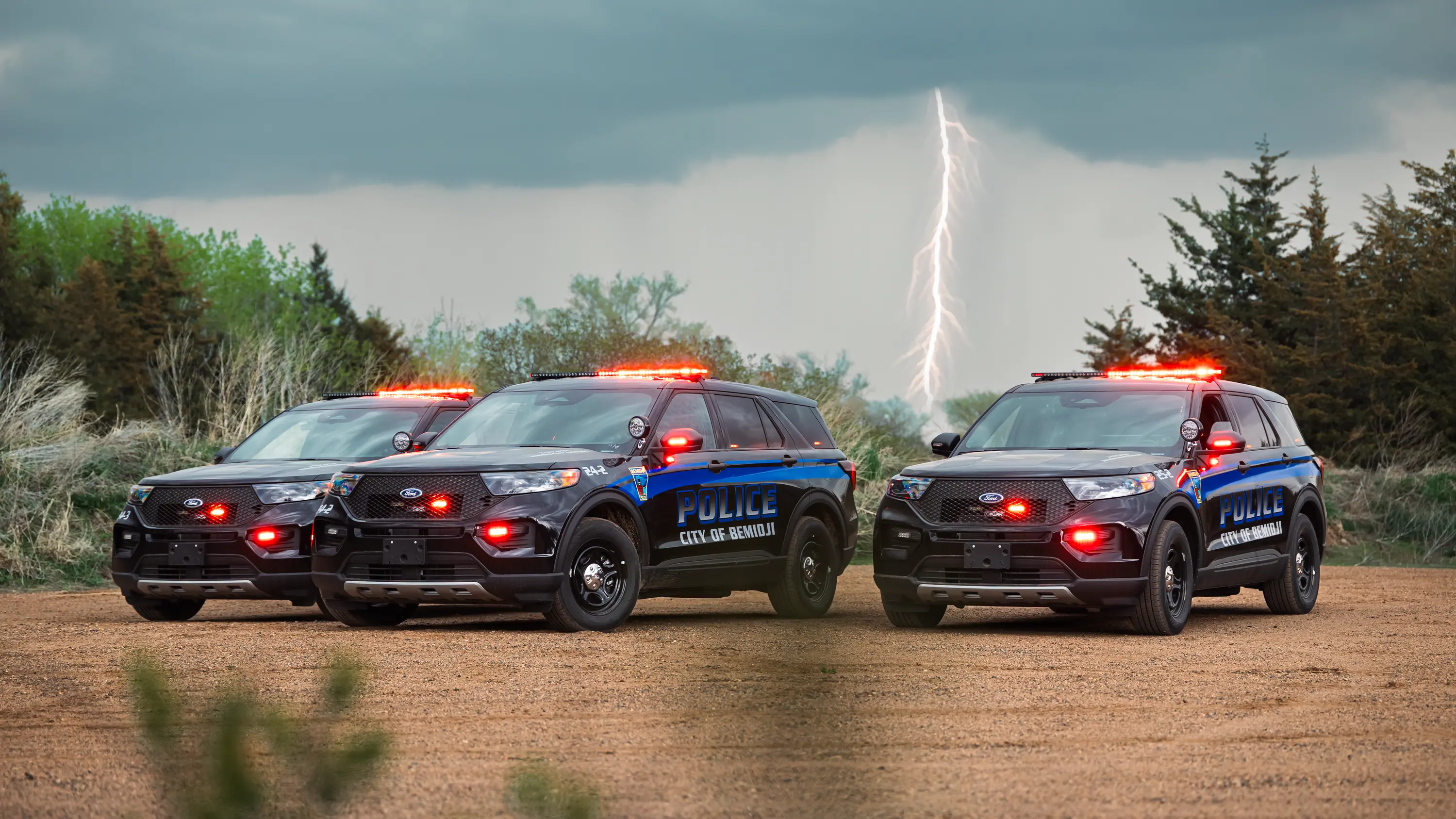 Three Bemidji Police SUVs with emergency lights on, representing coordinated fleet upfitting and consistent vehicle builds