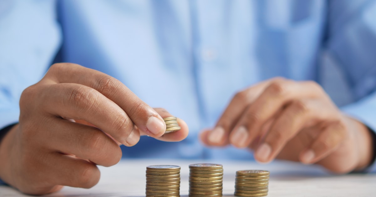 Stacking coins to illustrate saving money and tracking personal finances