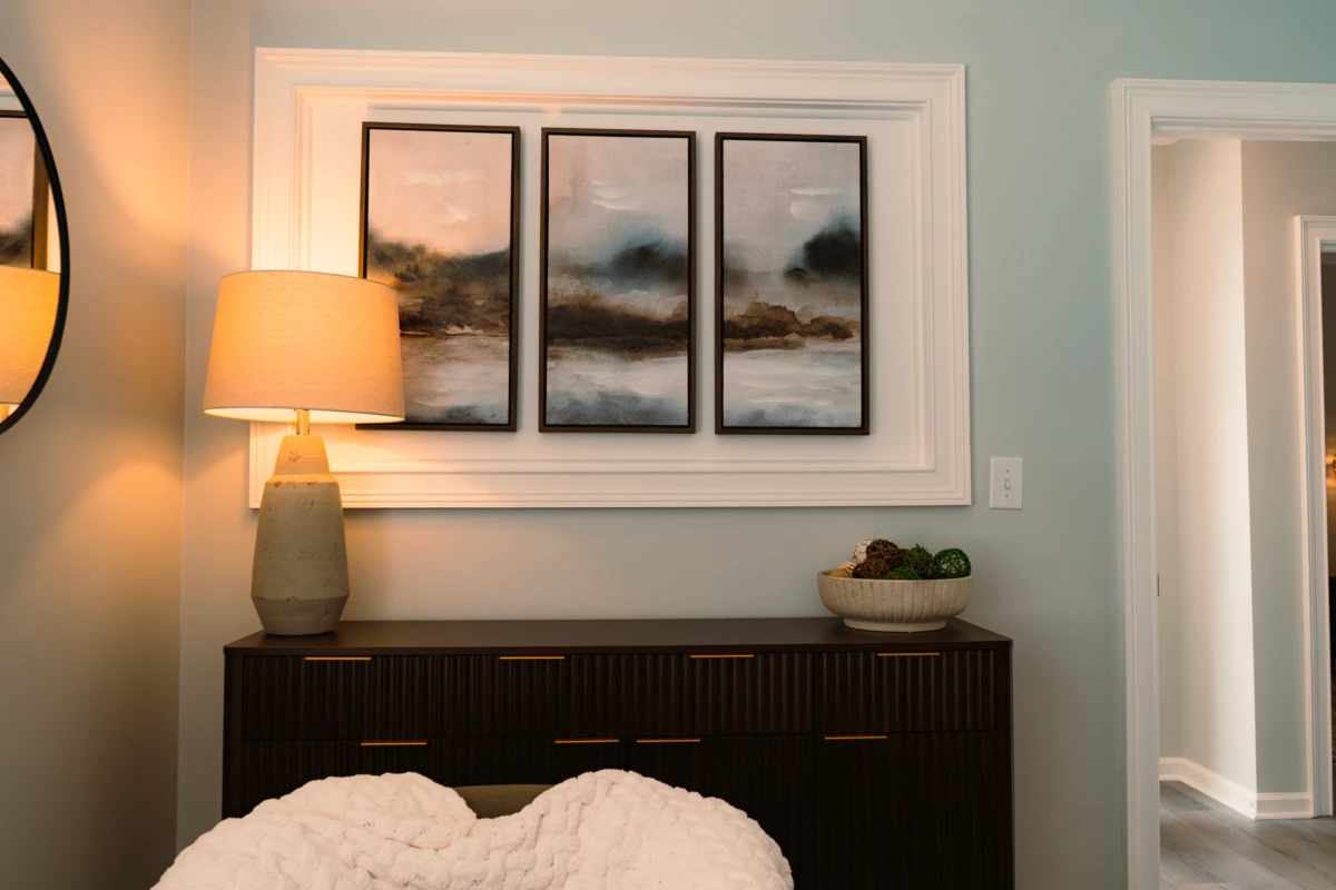Bedroom-style counseling space with framed landscape artwork above a bed or sofa.