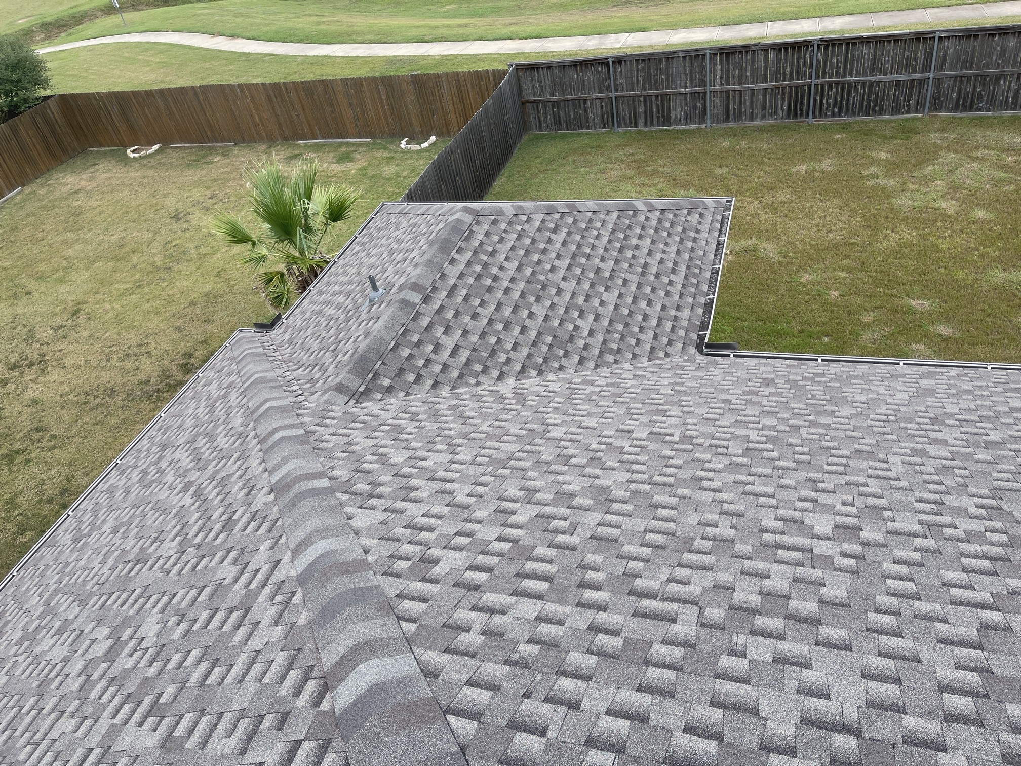 Architectural shingle roof appearance from our project files. This photograph does not identify a manufacturer or impact class.