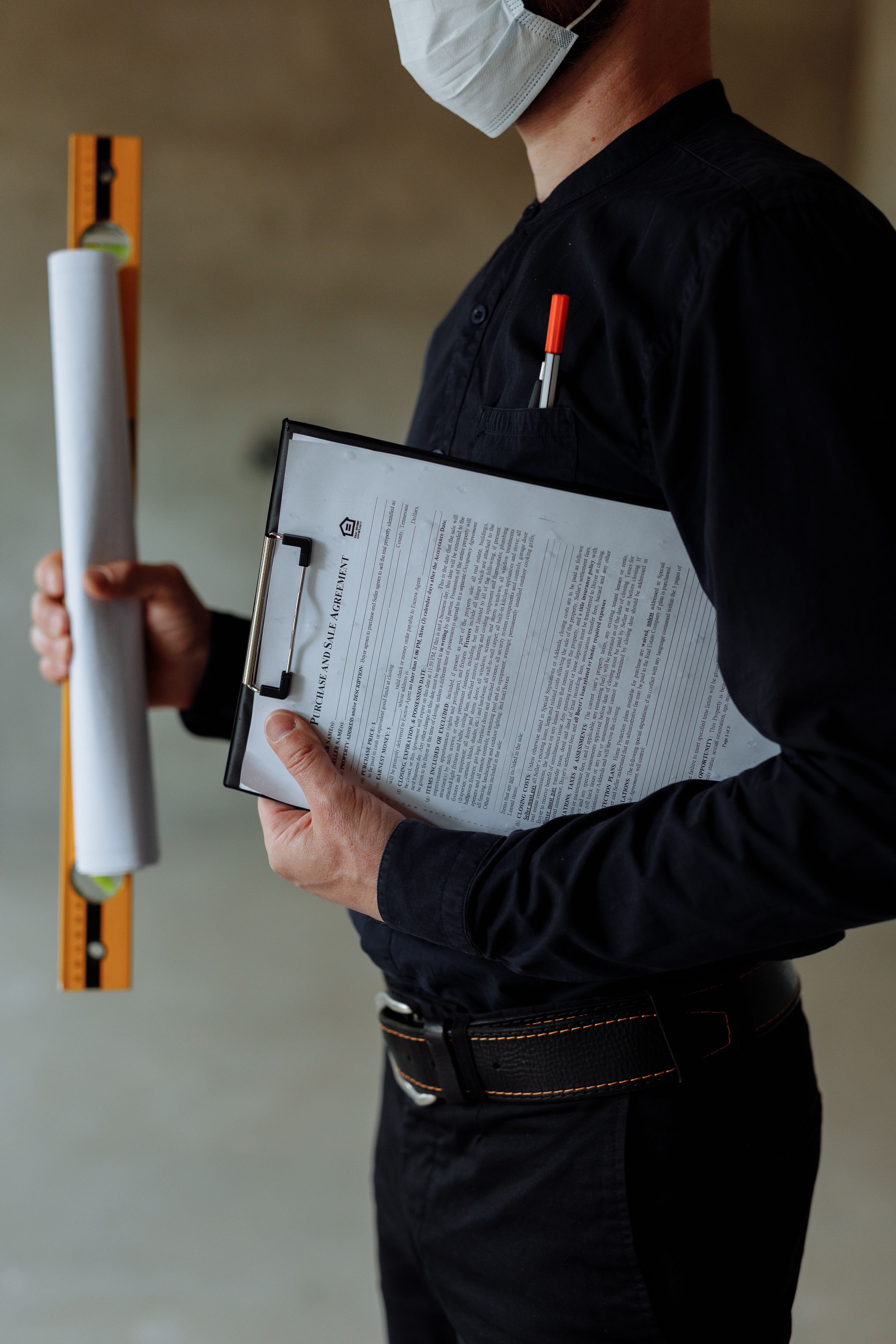 architect-wearing-a-face-mask-holds-blueprints-and-clipboard,-emphasizing-safety - thirdman (pexels)