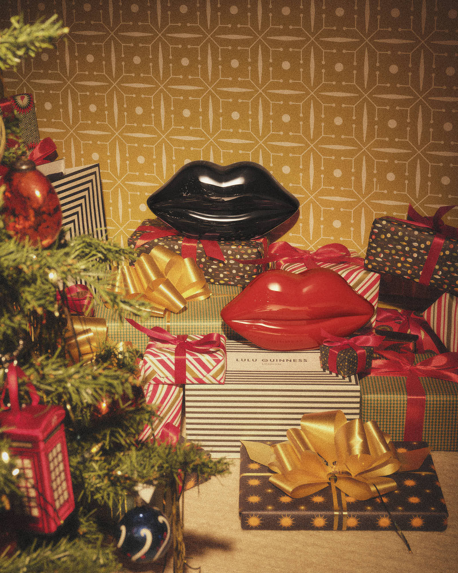Holiday gifts with festive bows, decorative lip sculptures, and a Christmas tree.