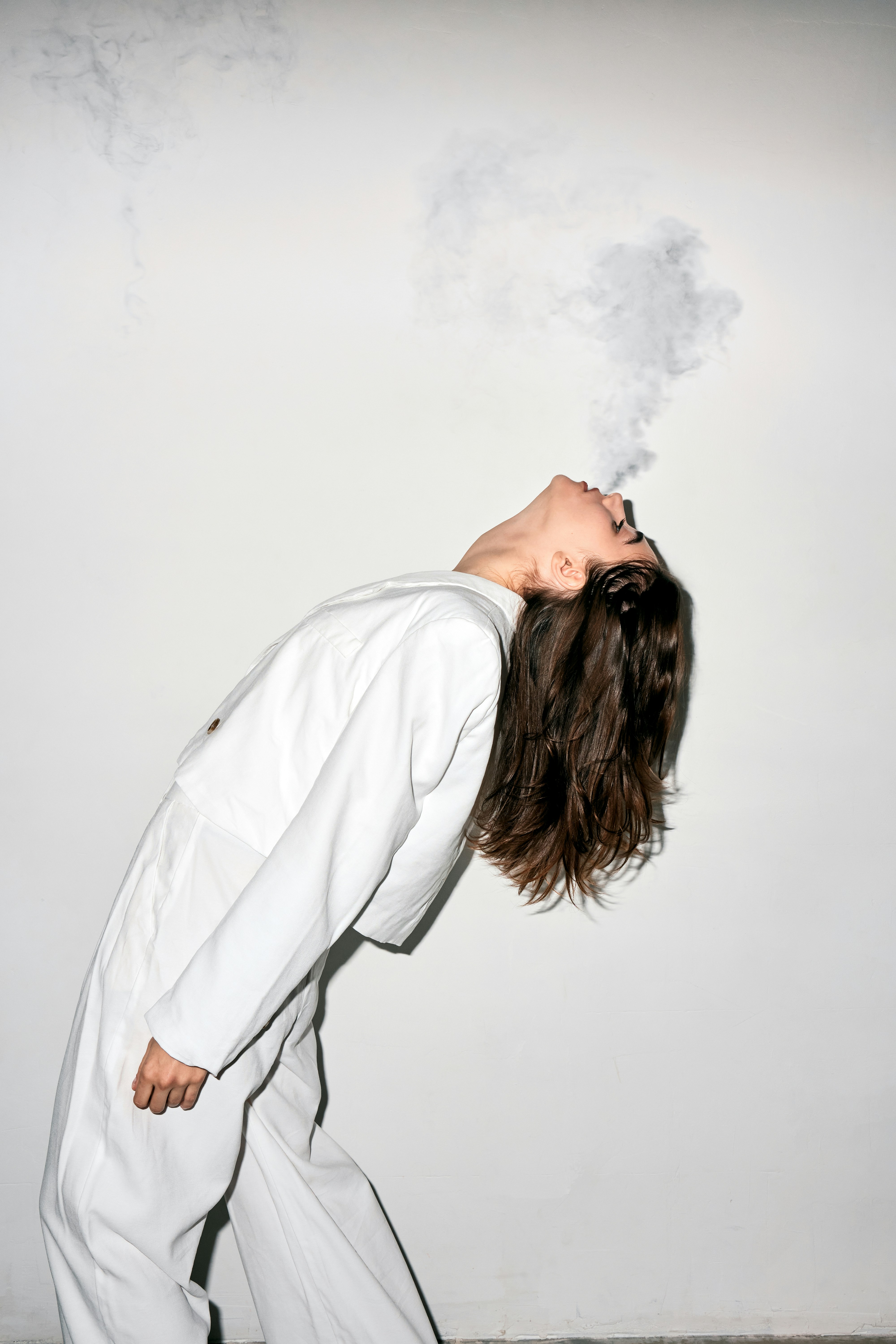 Woman blowing a puff of smoke