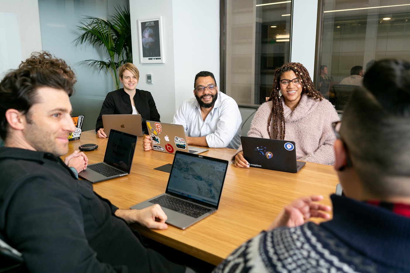 A product team working together around a table with laptops
