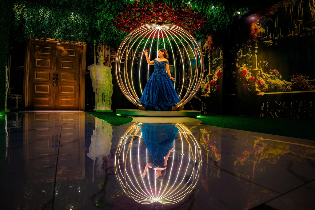 Debutante in the golden sphere reflected on the mirror floor of Pandora Hall