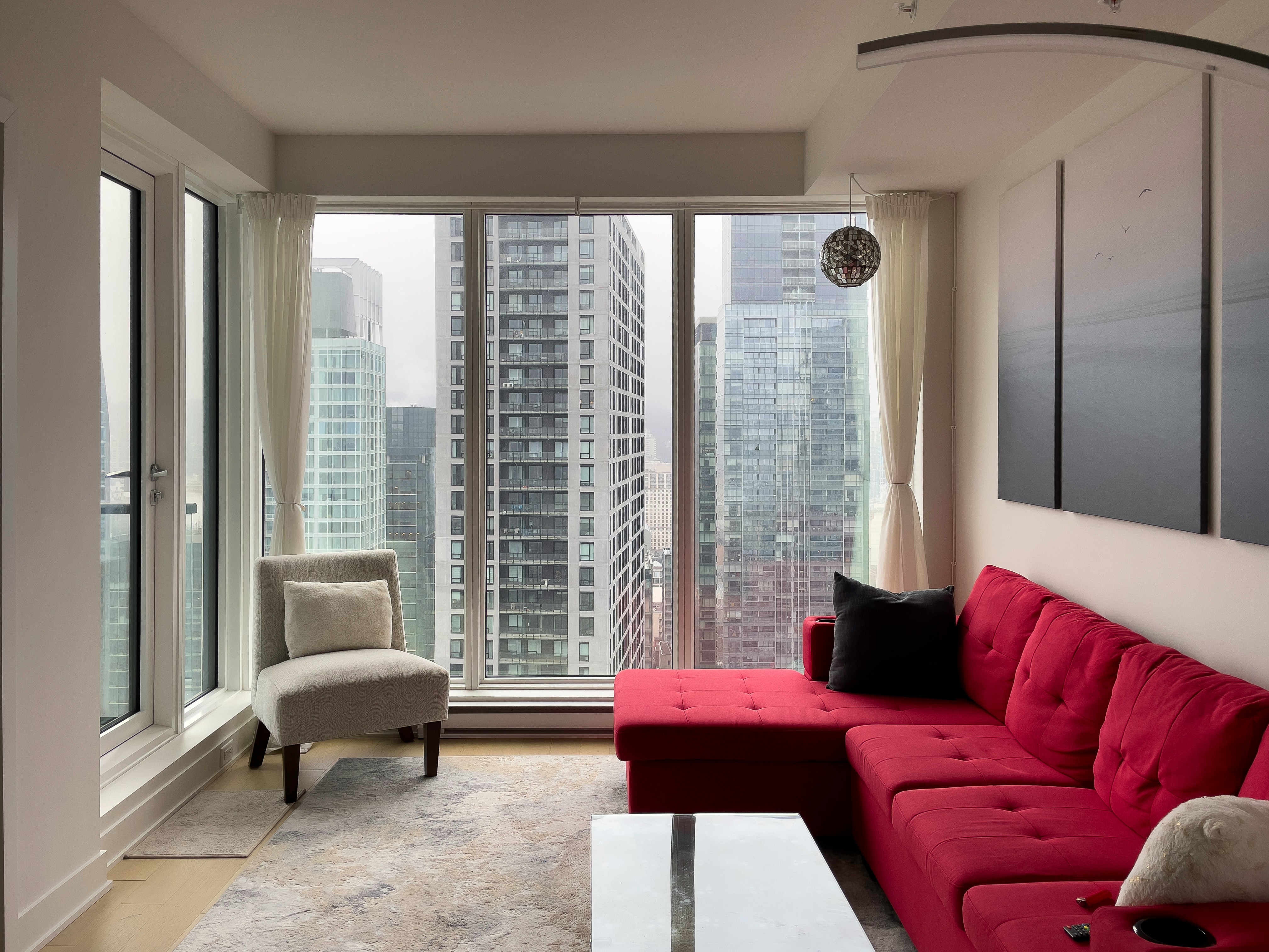 A living room filled with furniture and tall buildings