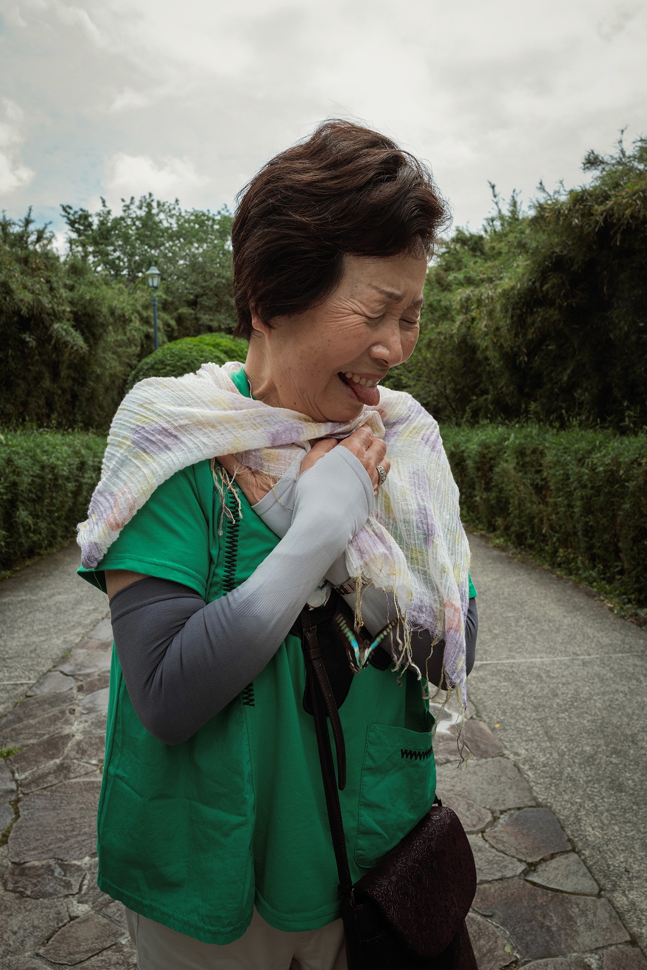 woman in green top pulling face butterly