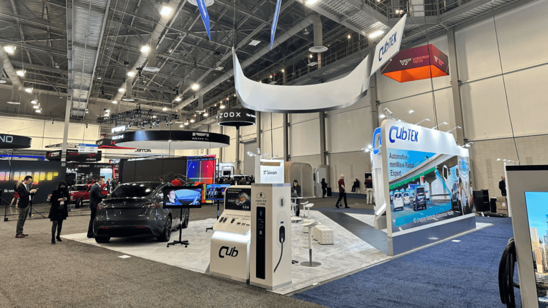 automotive engineering exhibit booth featuring test equipment displays and structured discussion space for validation teams