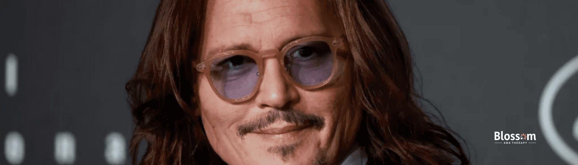 Johnny Depp, suspected with autism, styled in long hair and sunglasses at an event in Virginia.