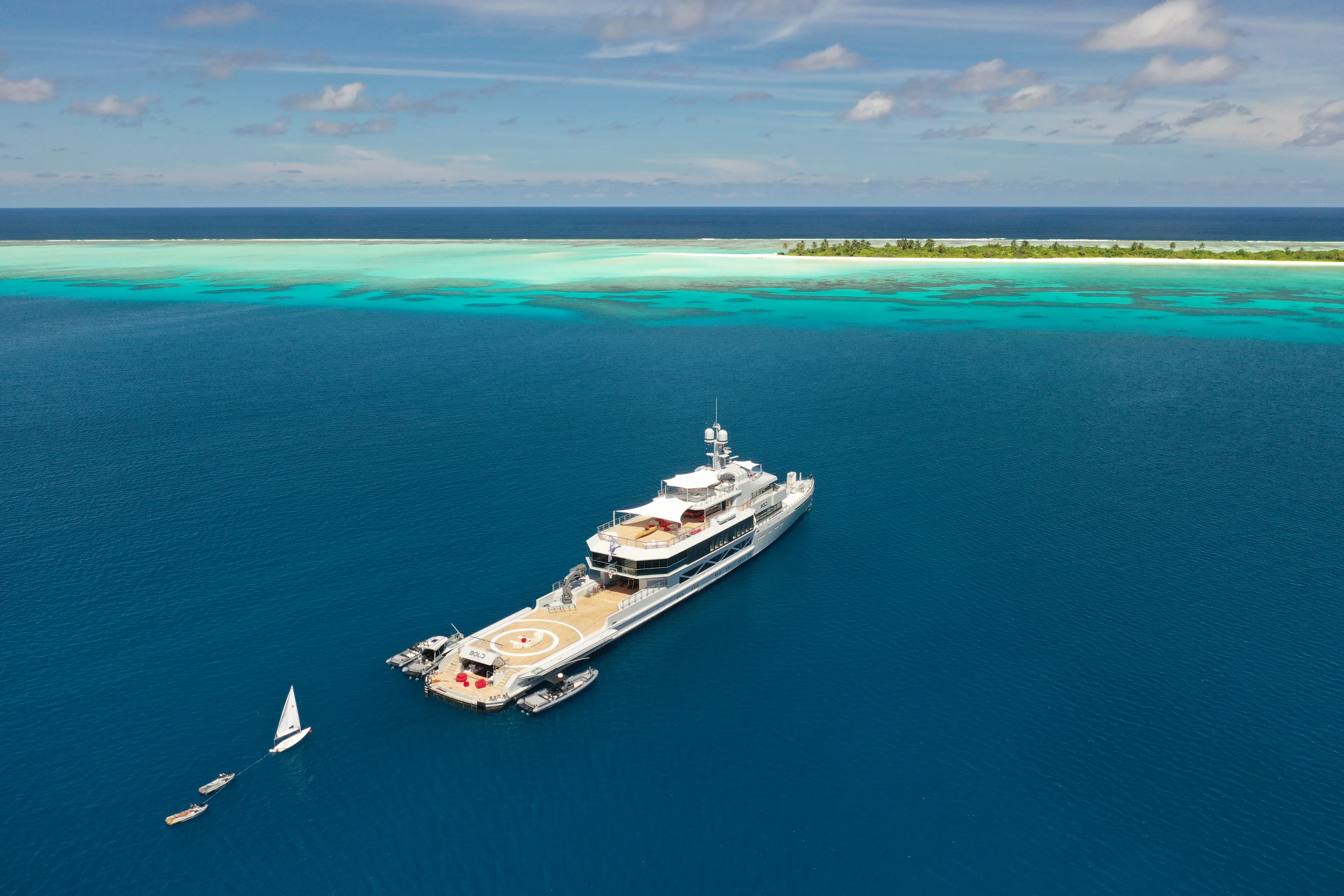 Sunlit minimalist corner with bench, artwork and plant.