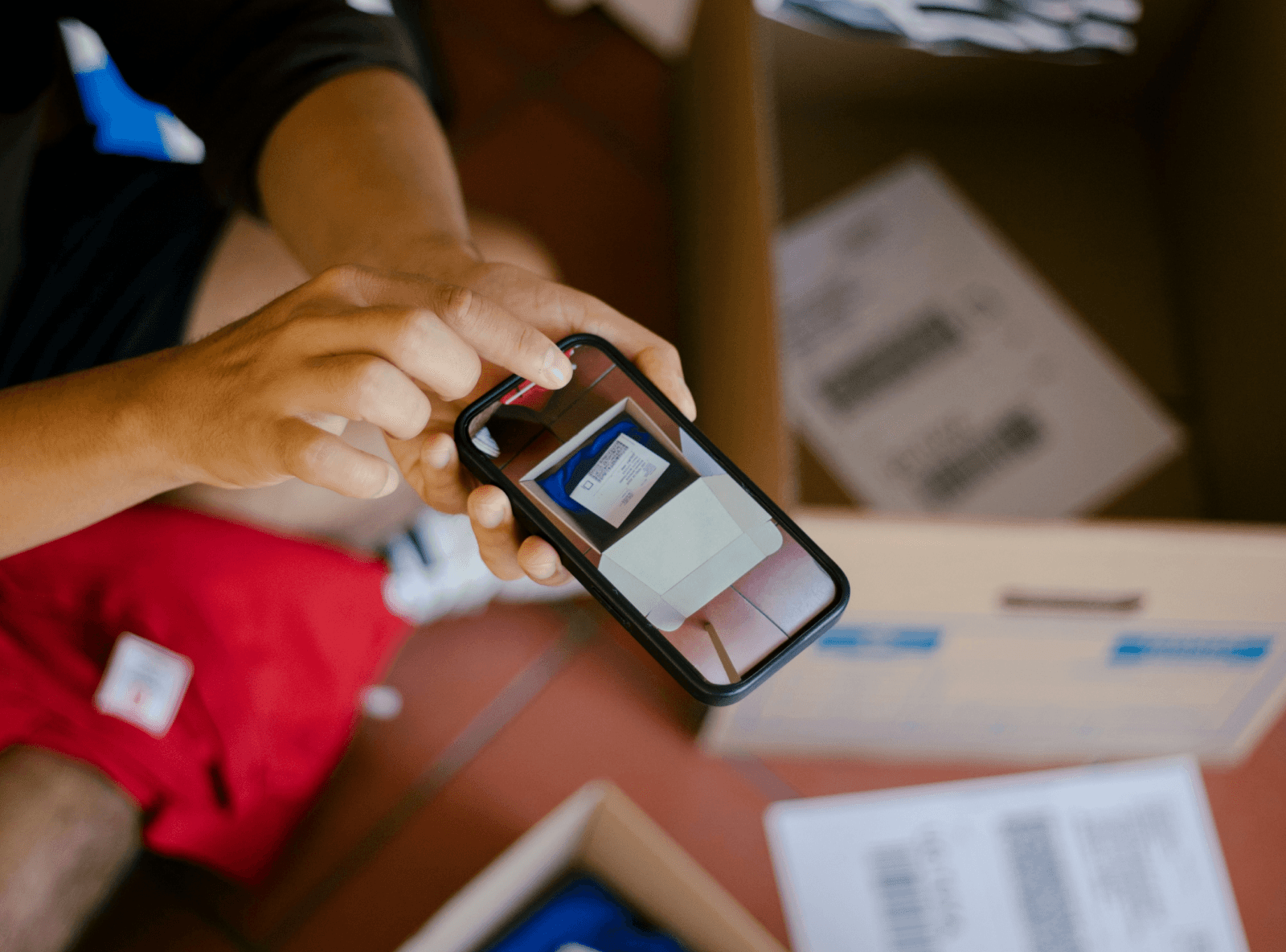 A barista handing a takeout bag to a female customer.