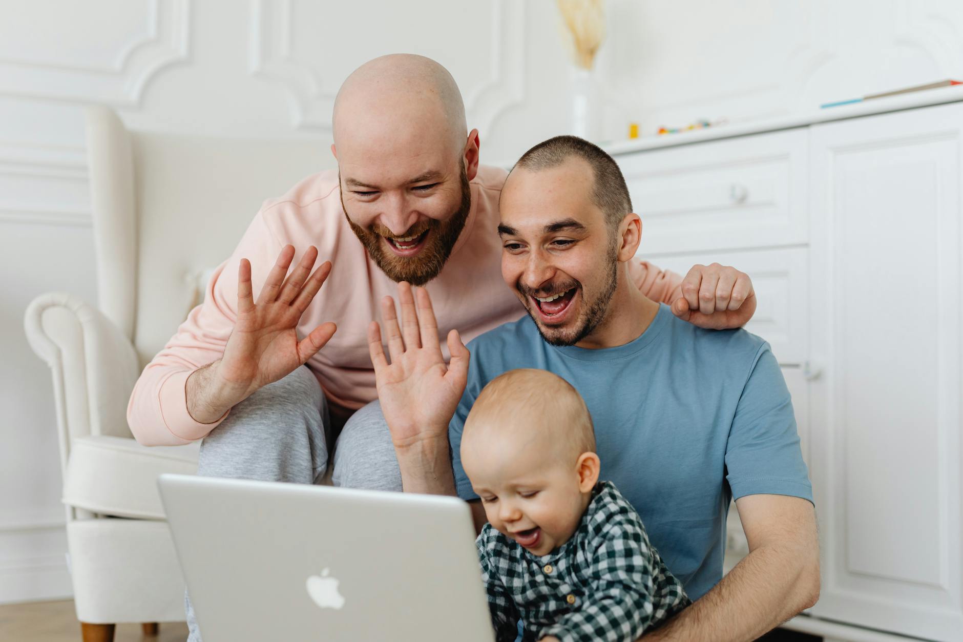 A parent and child sit together at a kitchen table comparing different online middle schools on a tablet screen.