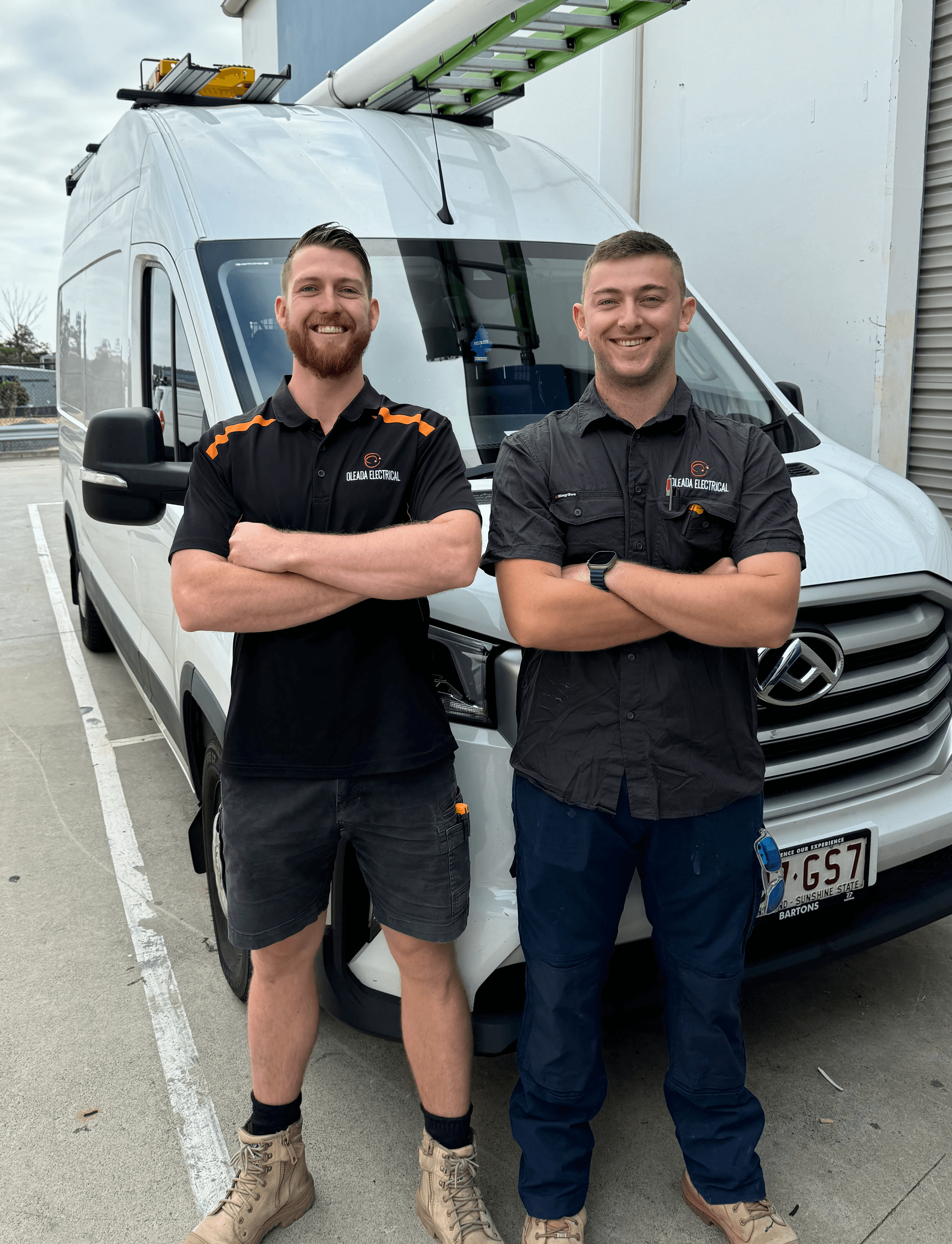 man wearing blue polo shirt with building background