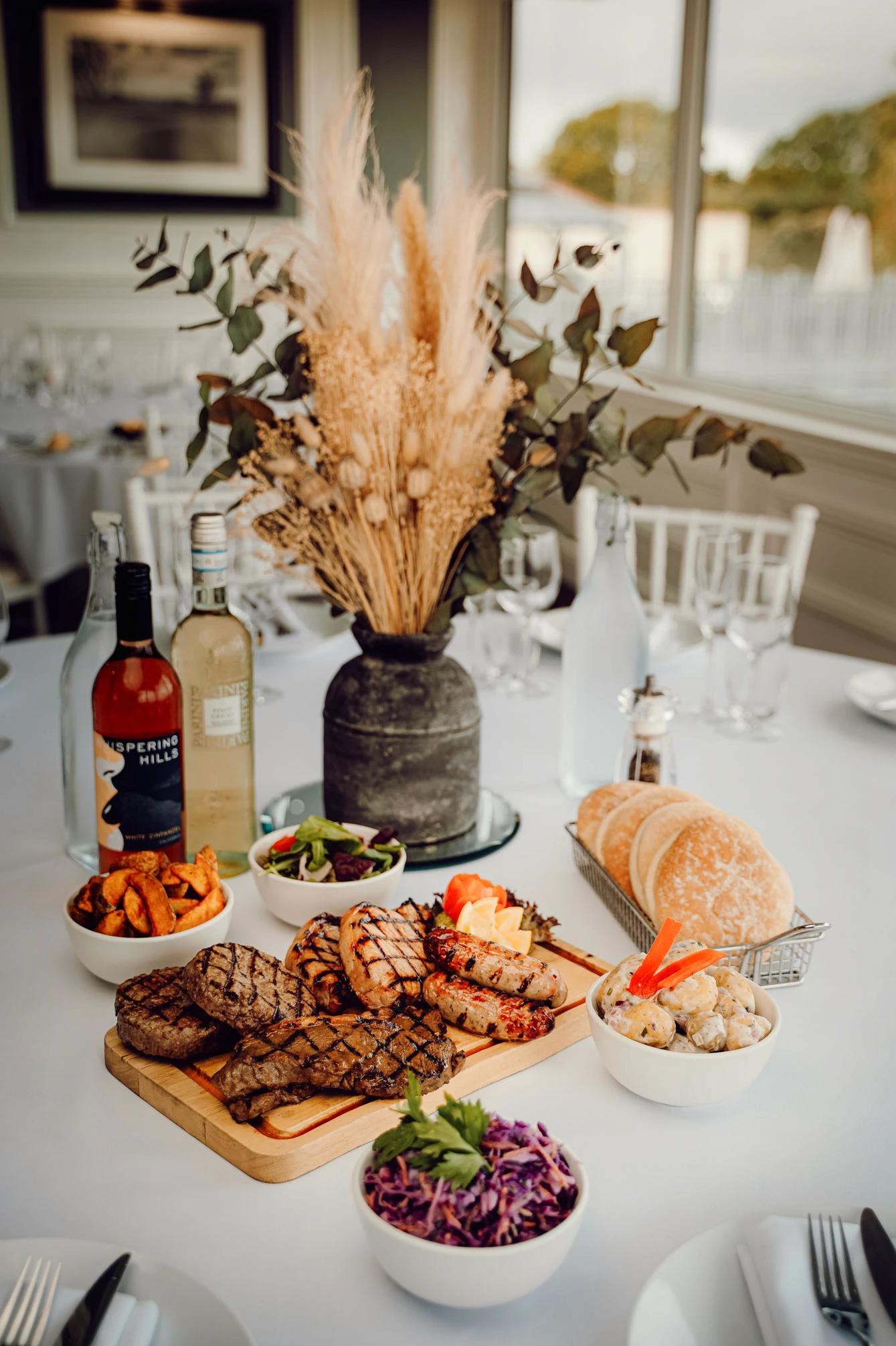 A lavish buffet table is elegantly set, featuring an assortment of appetisers.