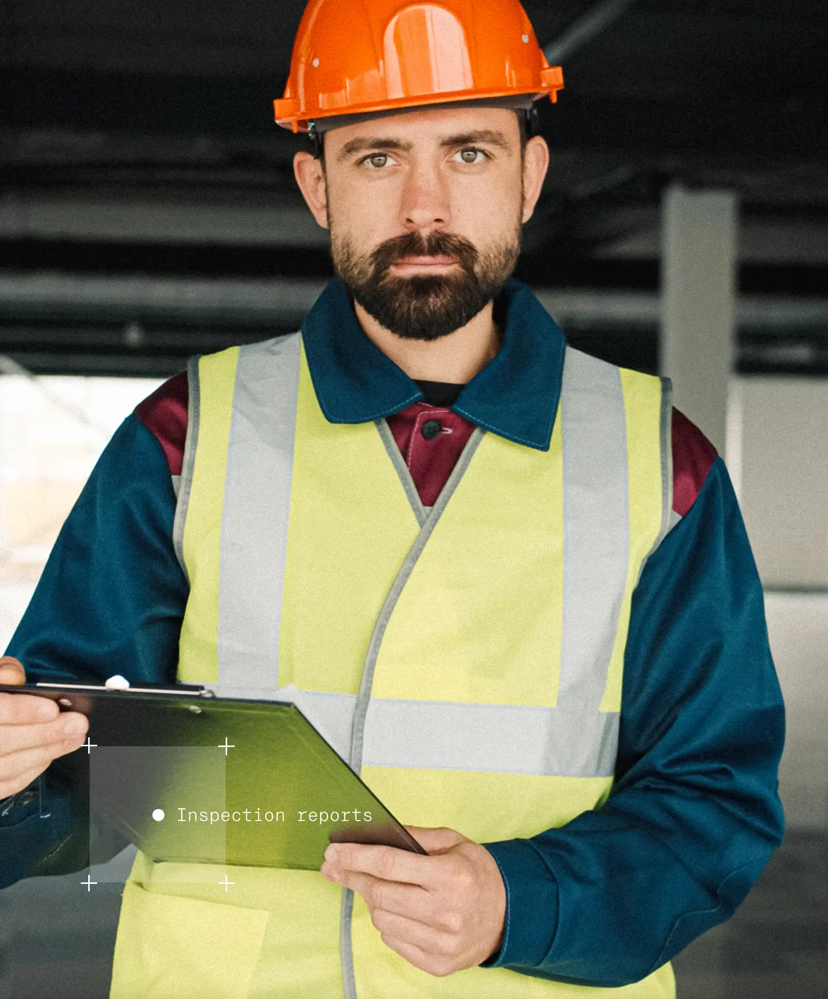 Photo of a man in a High Vis vest, with a clipboard and helmet