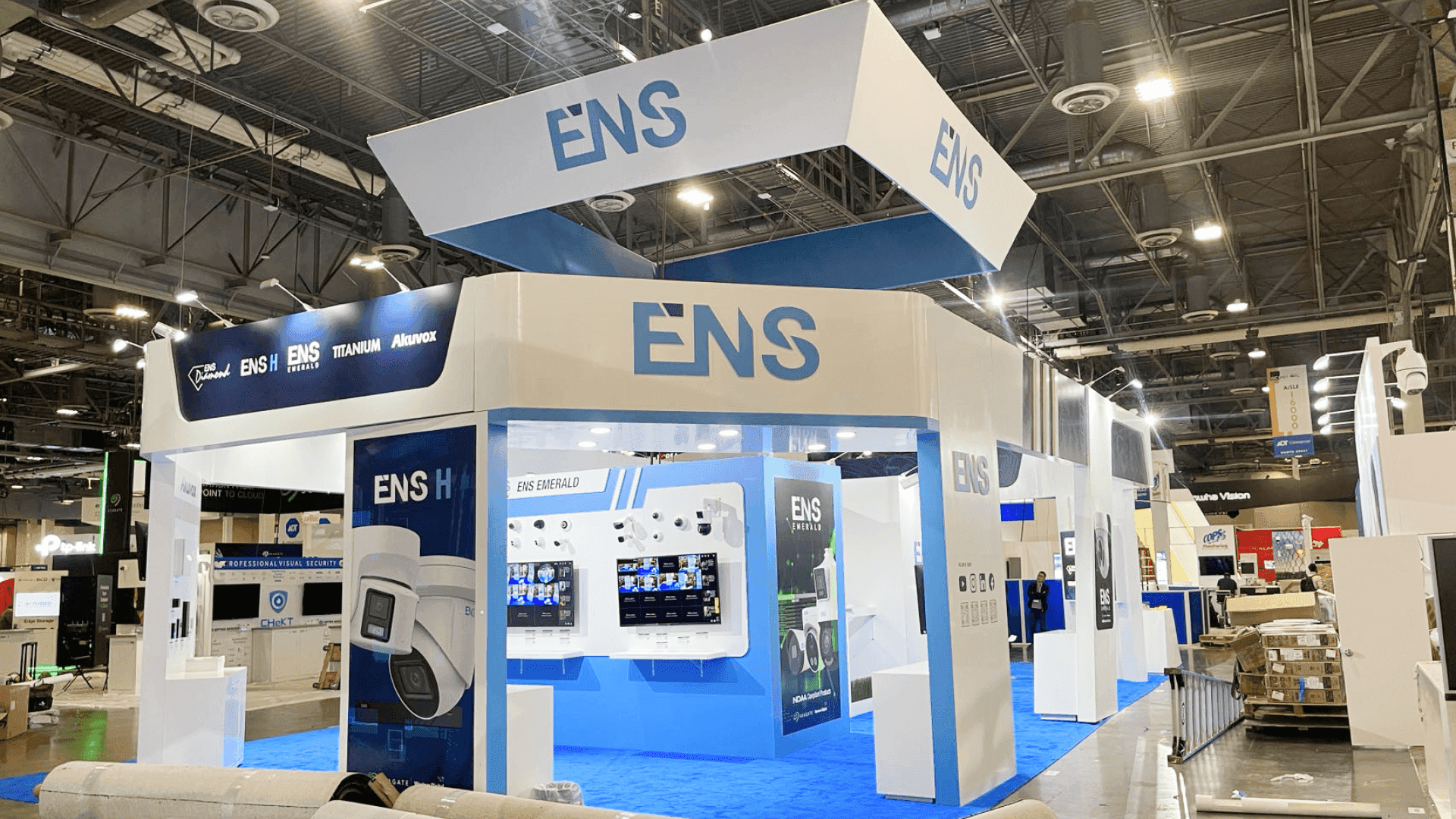 Digital signage display booth at Las Vegas Convention Center arranged with branded system graphics and open-entry demo layout