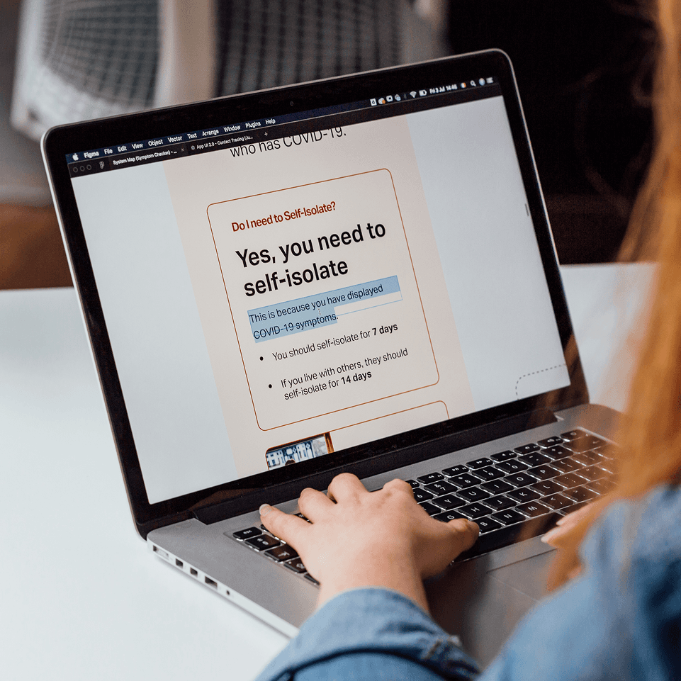 Person holding a smartphone showing the Resilico app with flood alerts and safety options.