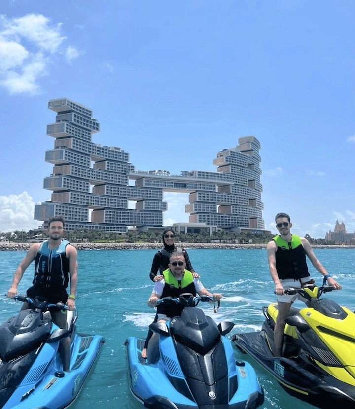 A group of riders on jet skis in front of The Royal Atlantis hotel during a guided Atlantis tour in Dubai