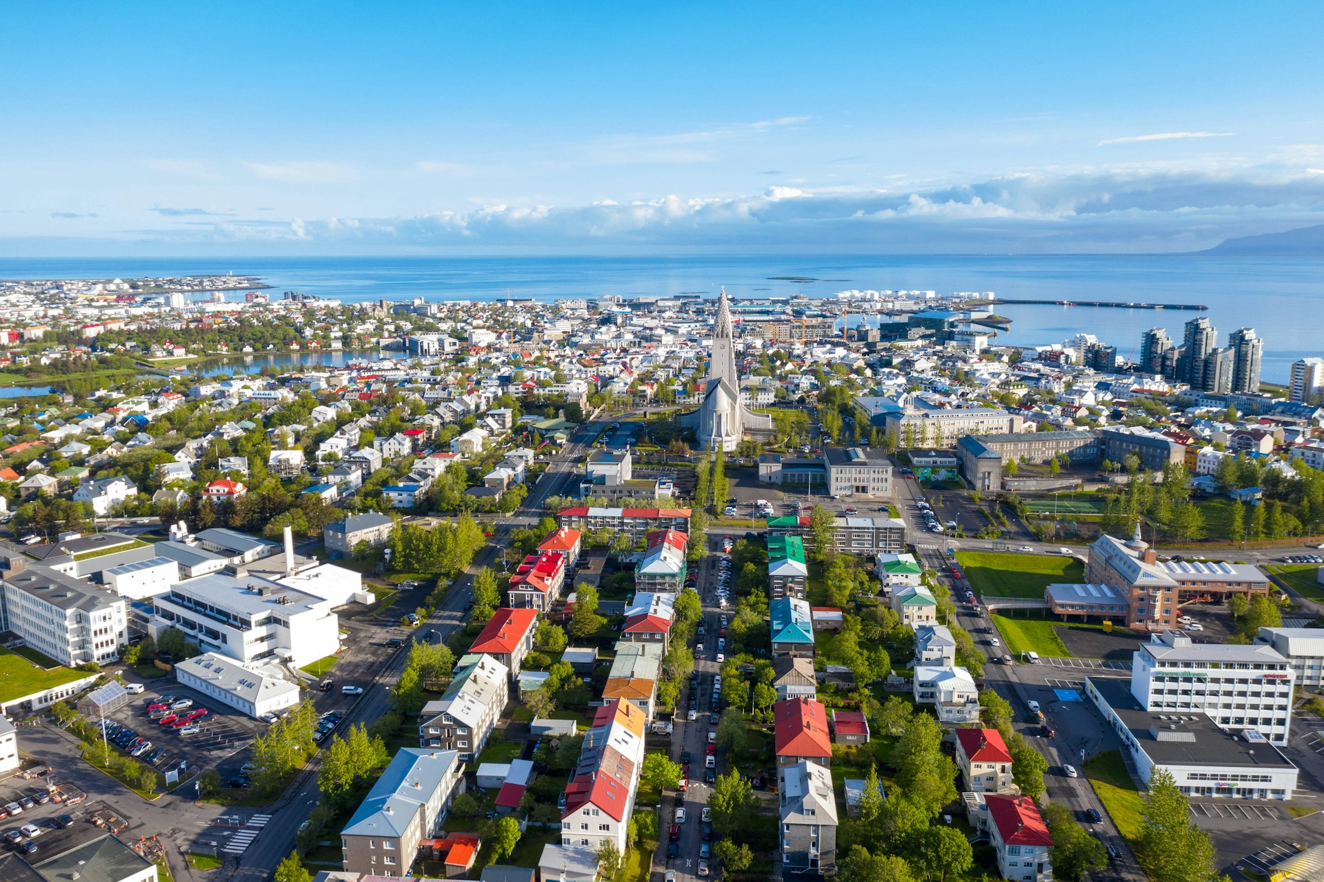 Reykjavik cityscape features Hallgrimskirkja church near Faxafloi Bay on a bright summer day.