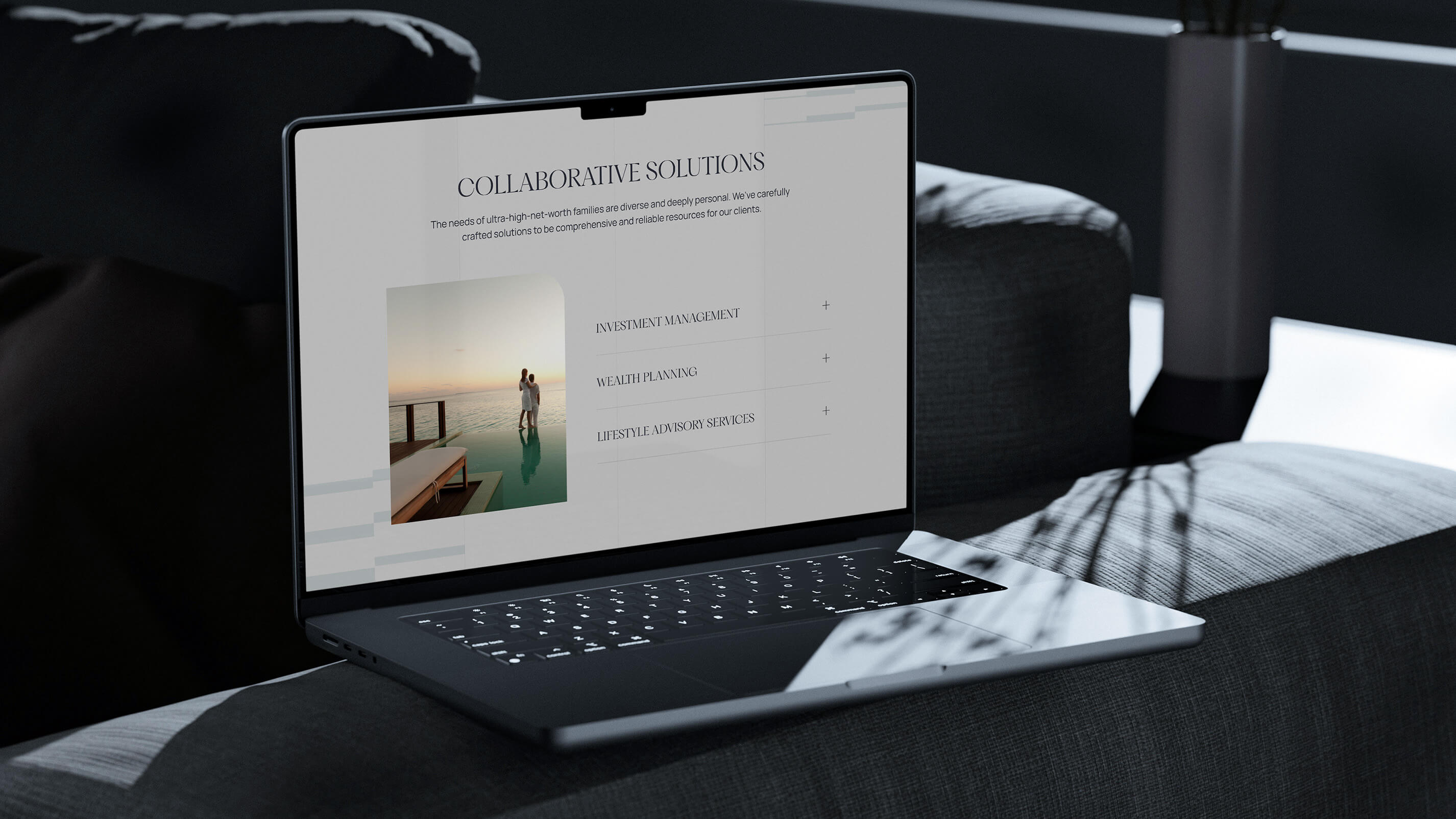 Macbook Pro laptop resting on arm of couch showing the Fountainhead MFO website.