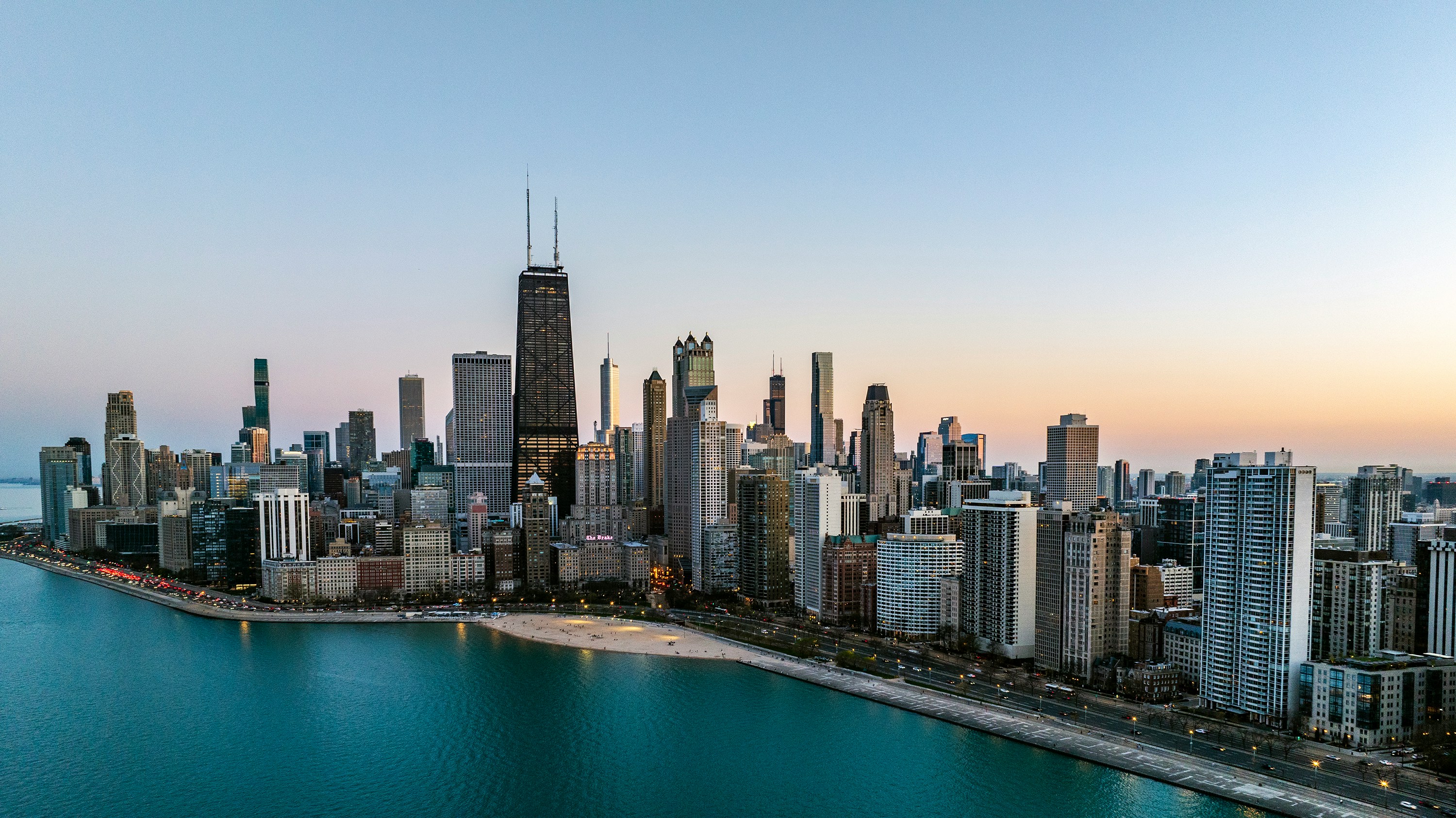 an aerial view of a large city next to a body of water