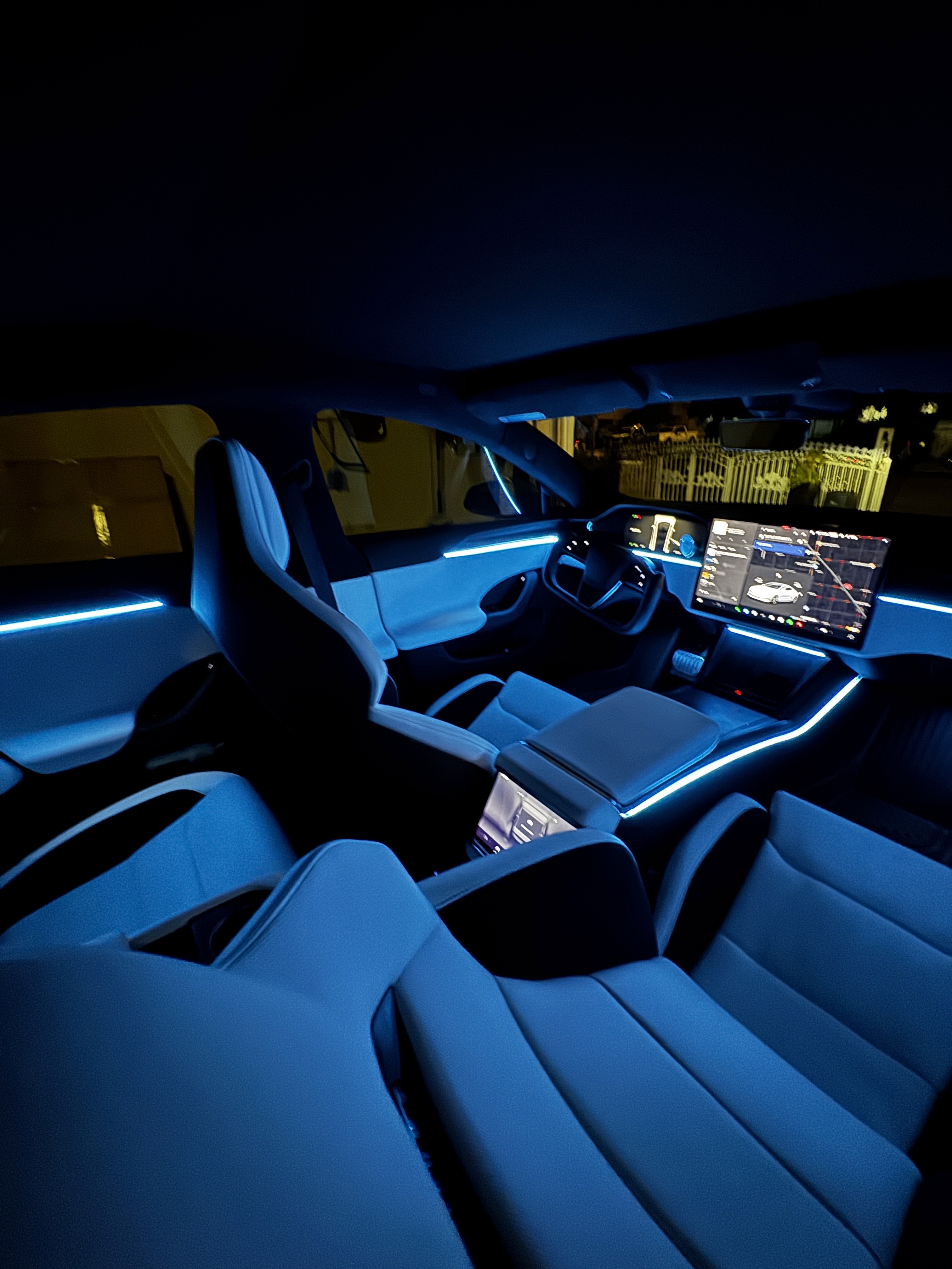 Tesla Model Y rear seats with ambient lighting reflecting on trim