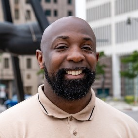 Possible member smiling and looking at the camera.