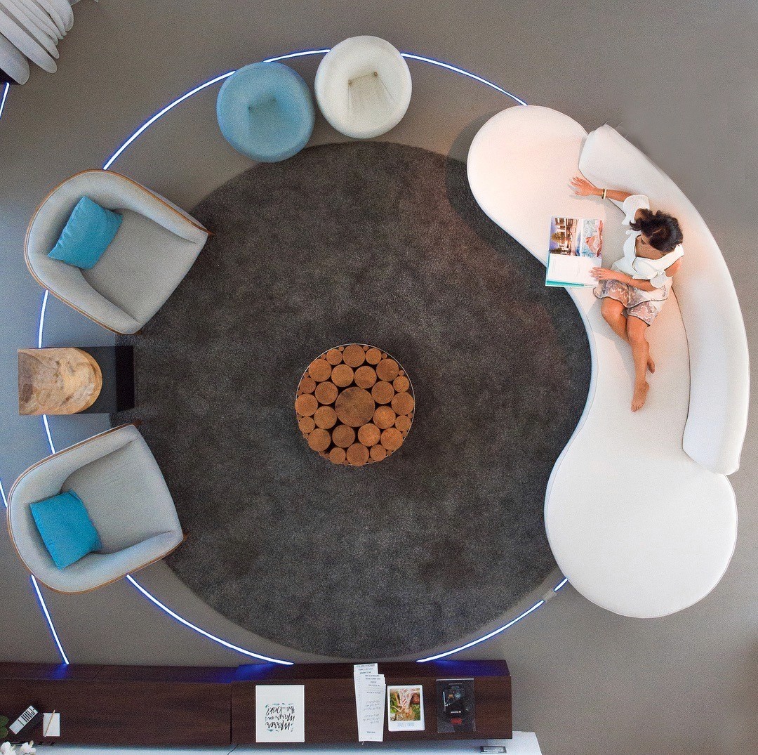 Black-and-white party photo of a smiling man in a check blazer among a crowd.