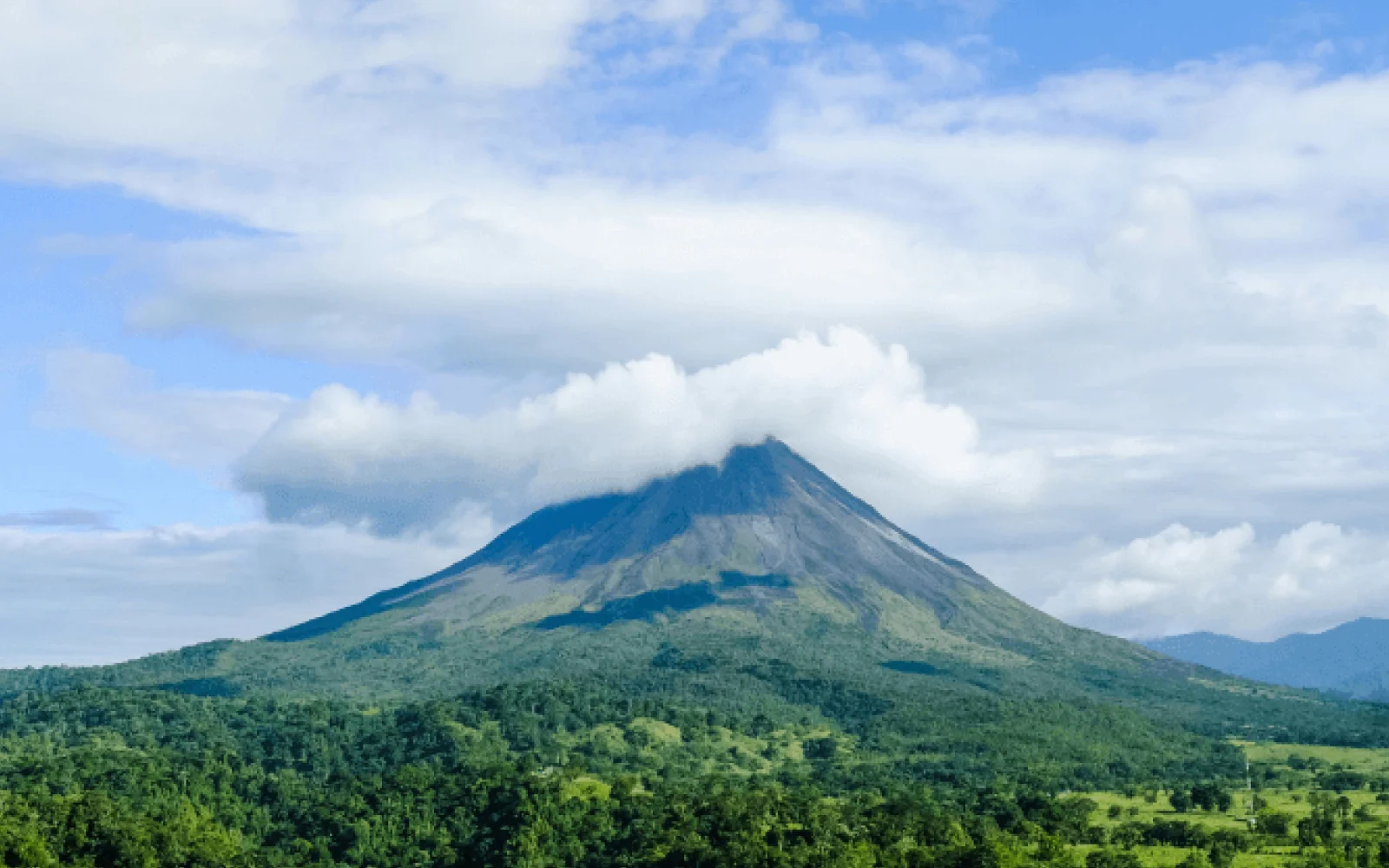 Arenal volcano with clouds covering the top