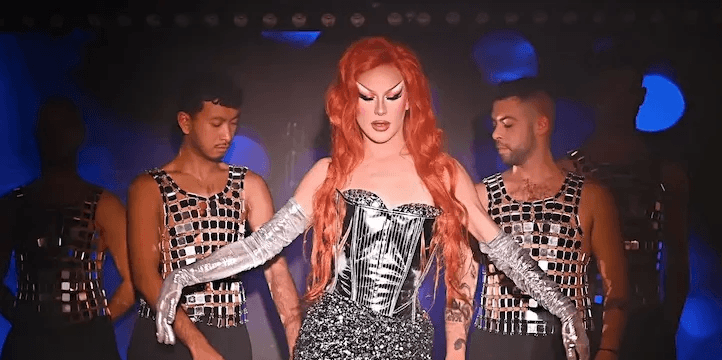 An extravagant drag queen performing an interactive show during the queer Love Bazar party in Paris