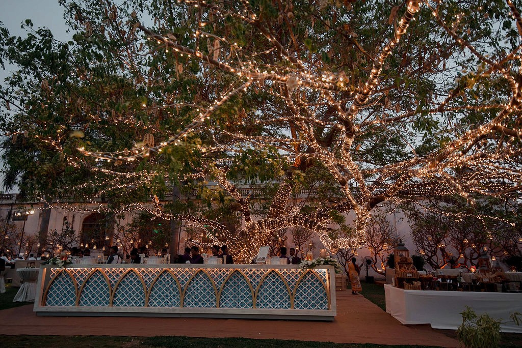 Stone kitchen with cabinets, exposed beam ceiling, terracotta floors.
